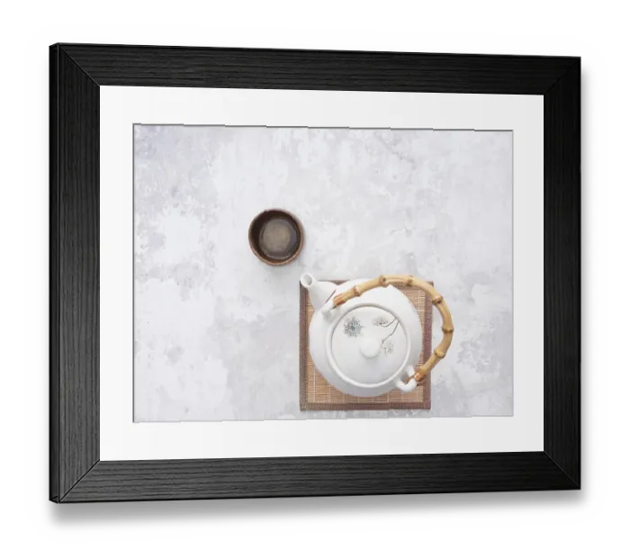 Framed Print : White teapot with bamboo handle and small wooden teacup on bamboo mat