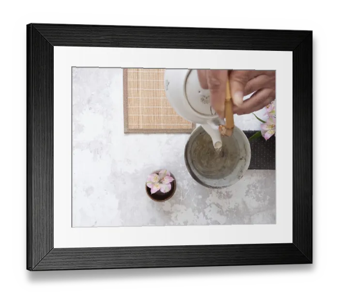 Framed Print : Hands gracefully pouring tea from a white teapot into a ceramic bowl Framed Print : Hands gracefully pouring tea from a white teapot into a ceramic bowl