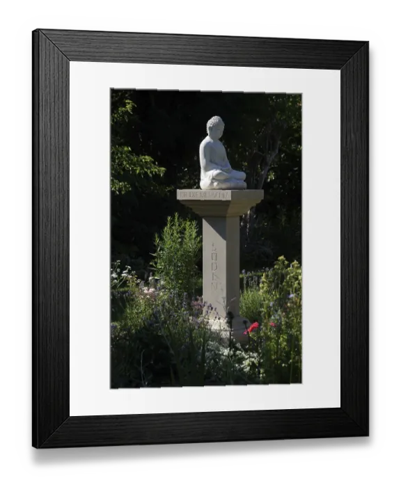 Framed Print : Buddha statue on a stone pillar in the garden