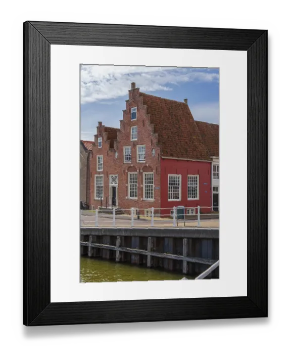 Framed Print : Charming red half-timbered house on the waterfront with historic architecture Framed Print : Charming red half-timbered house on the waterfront with historic architecture