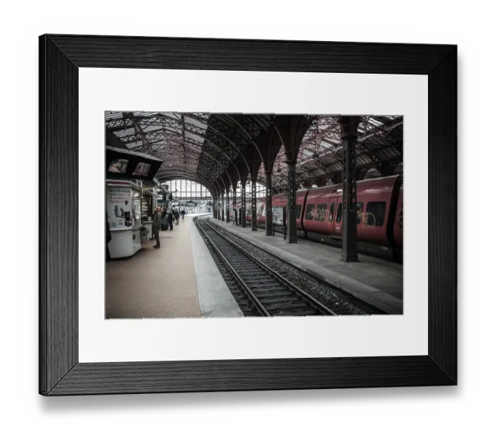 Framed Print : Busy train station with red trains and passengers waiting on the platform in Copenhagen