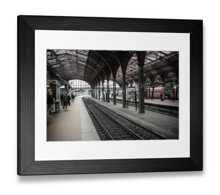 Framed Print : Passengers at a train station with red trains and arched architecture in Copenhagen Framed Print : Passengers at a train station with red trains and arched architecture in Copenhagen