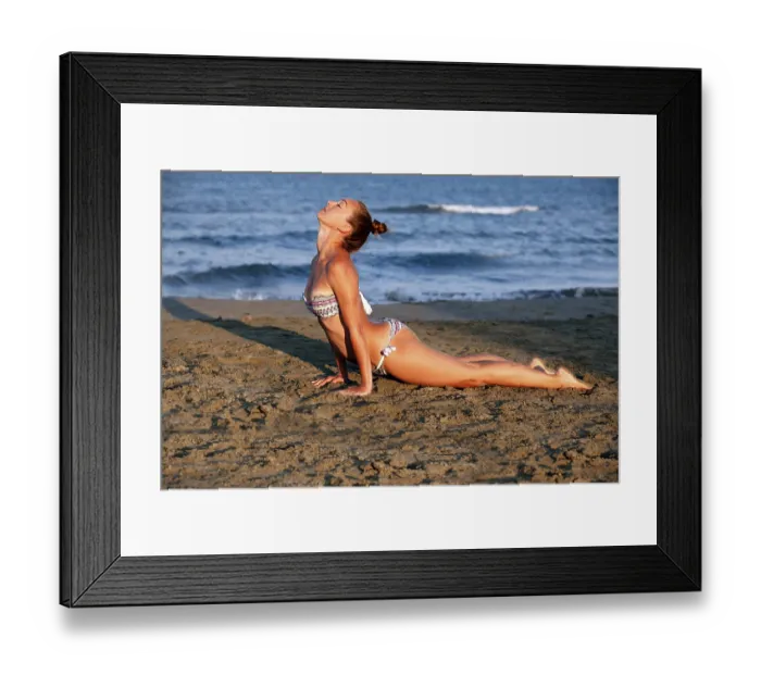 Framed Print : Young woman practicing yoga on the sea beach at sunset Framed Print : Young woman practicing yoga on the sea beach at sunset