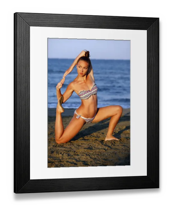 Framed Print : Young woman practicing yoga on the sea beach at sunset Framed Print : Young woman practicing yoga on the sea beach at sunset