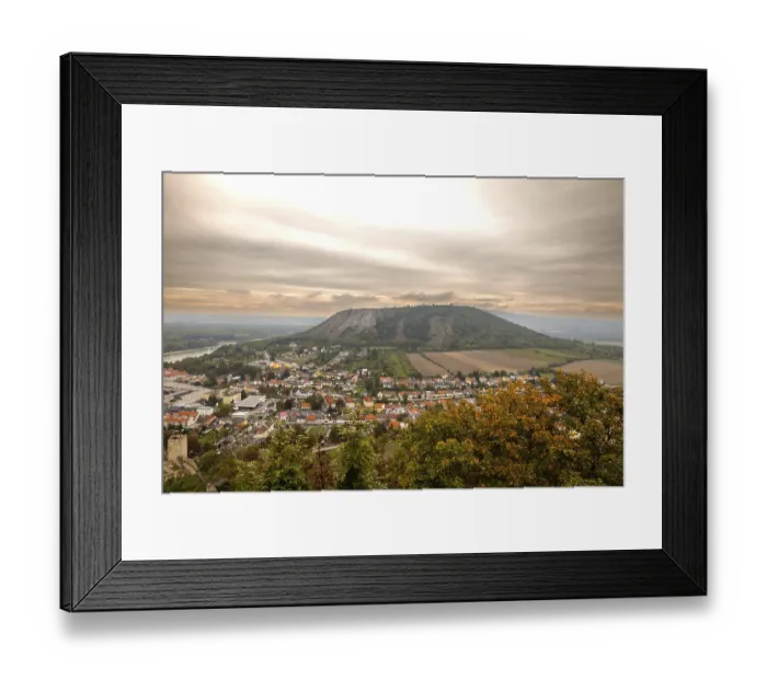 Framed Print : View of a town and a hill on the horizon under a vaste sky