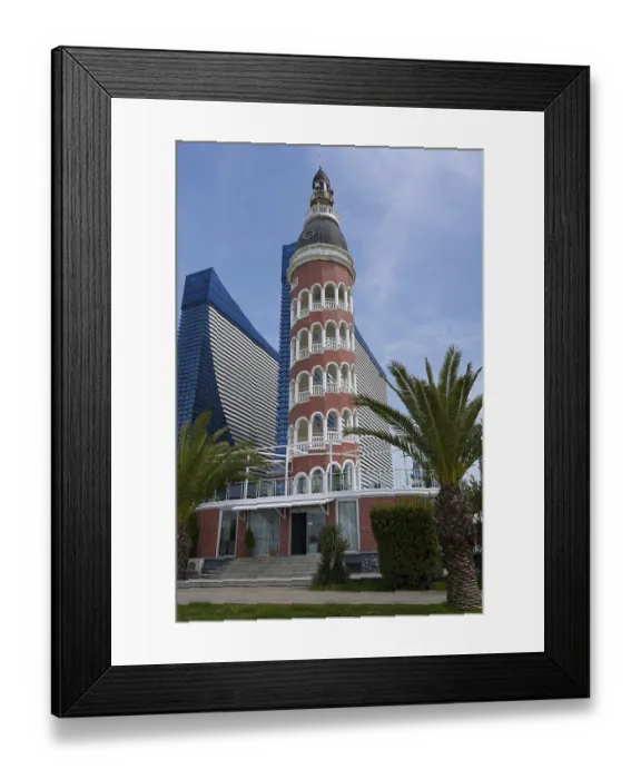 Framed Print : A lighthouse in front of a modern skyscraper