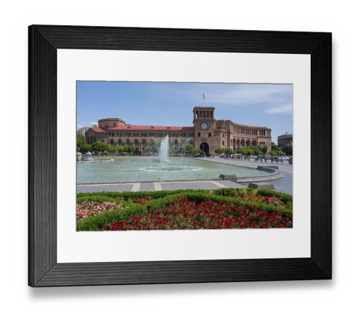 Framed Print : Large square with fountain, surrounded by flower beds and a historic building with clock