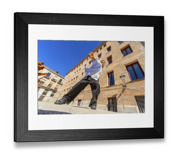 Framed Print : Young man actively performing a passionate flamenco move on a city street