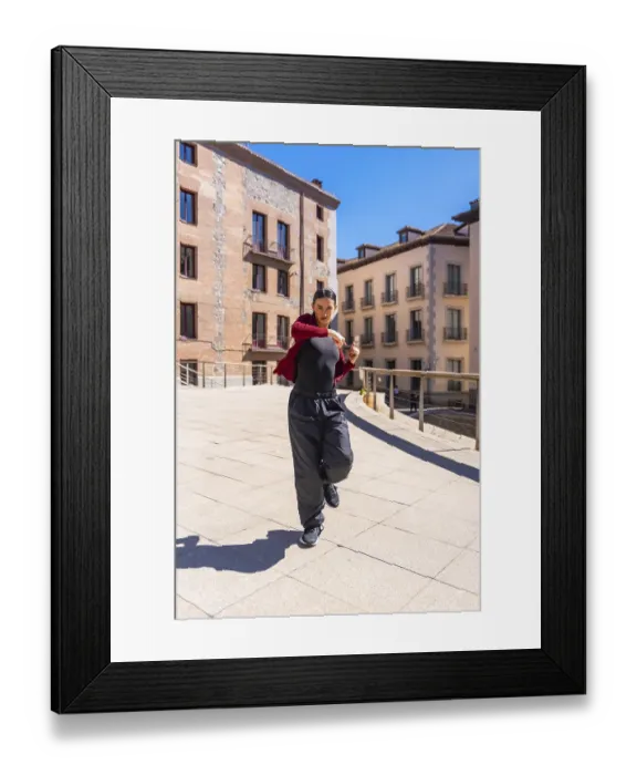 Framed Print : Young woman dancer performing dynamic contemporary routine on a sunny city street