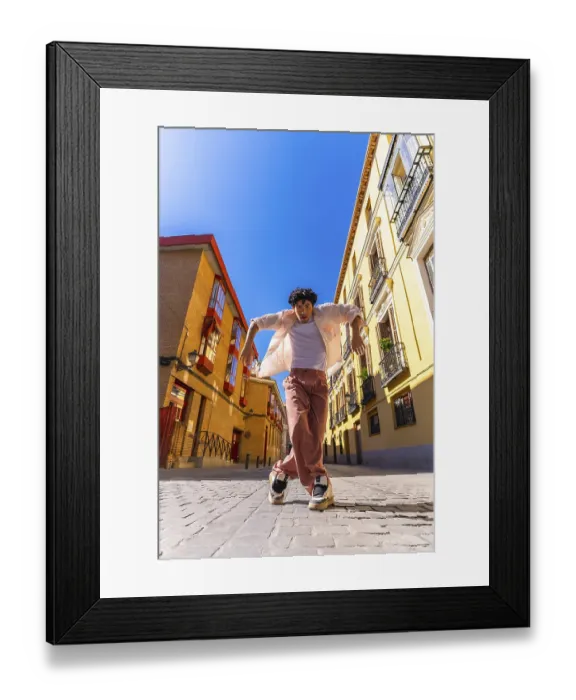 Framed Print : Stylish young man with intense expression executing a dynamic street dance move on cobblestones in a vibrant european