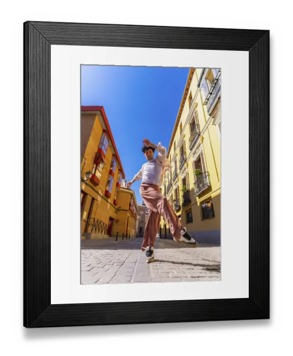 Framed Print : Young man dancer performing a dynamic street dance move in a vibrant old city urban setting under a clear blue sky