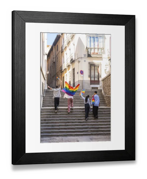 Framed Print : Young adults are joyfully walking up stone stairs in a european city