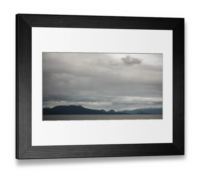 Framed Print : A tranquil seascape with mountains