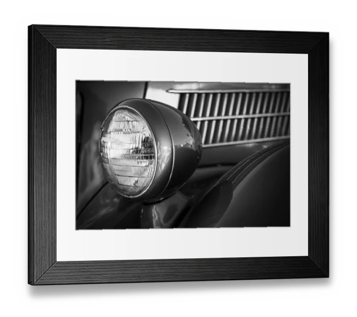 Framed Print : Detailed black and white close-up of a vintage car's headlight and grille in St
