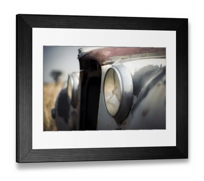 Framed Print : Close-up of a classic Jaguar car's weathered headlights