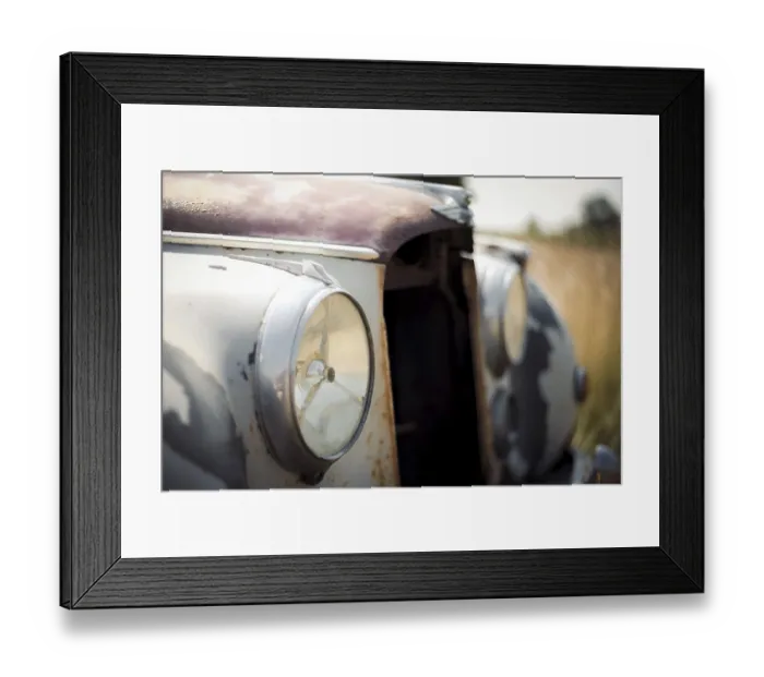 Framed Print : Close-up of a rusty vintage Jaguar car headlight and front body