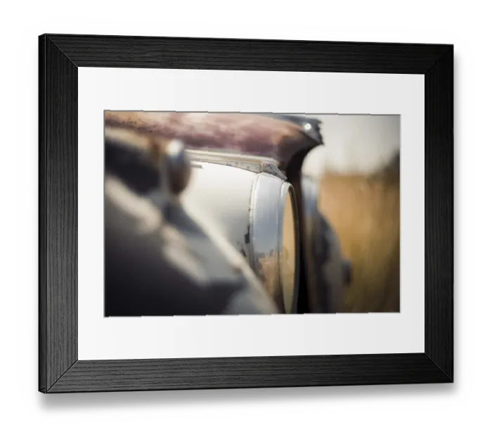 Framed Print : Blurred close-up of an old Jaguar car's headlight and surface with visible rust in rural Huron County