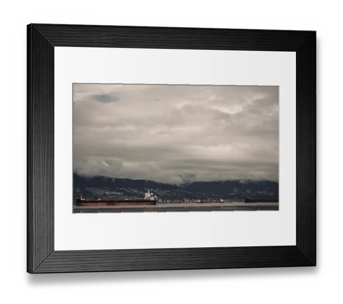Framed Print : Cargo ships on the ocean with a mountainous backdrop under a cloudy sky Framed Print : Cargo ships on the ocean with a mountainous backdrop under a cloudy sky