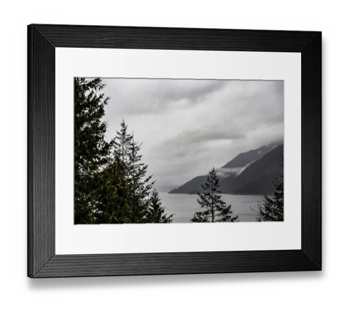 Framed Print : A view of a serene lake surrounded by trees