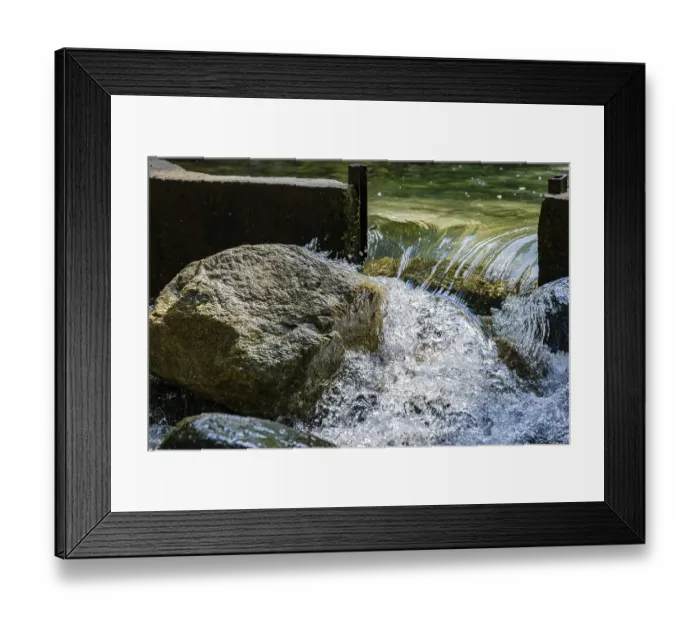 Framed Print : Water flows through an open dam