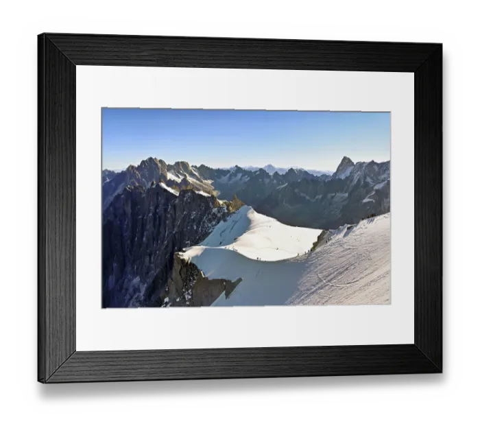 Framed Print : Mountaineers climb over a snow-covered ridge