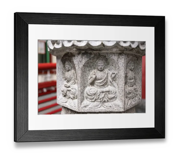 Framed Print : Small Buddha relief on stone lantern pedestal near the temple