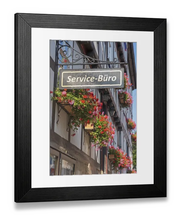 Framed Print : Service office, sign on a flower-decorated half-timbered house