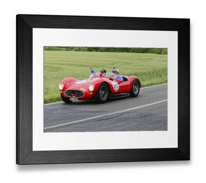 Framed Print : Two people joyfully driving a red Maserati on a country road Framed Print : Two people joyfully driving a red Maserati on a country road