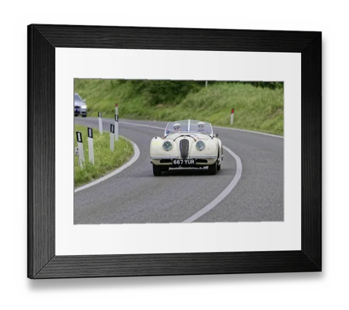Framed Print : White vintage convertible on a winding country road surrounded by nature Framed Print : White vintage convertible on a winding country road surrounded by nature