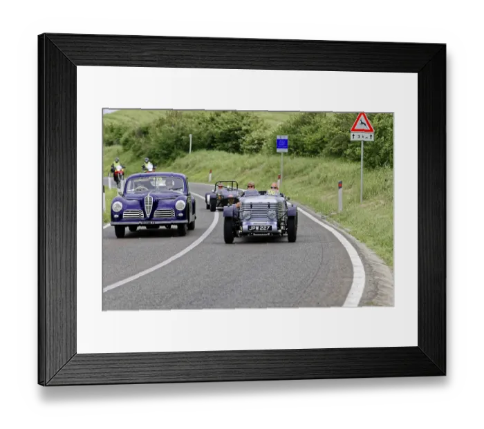 Framed Print : Purple vintage car and black car driving side by side on country road