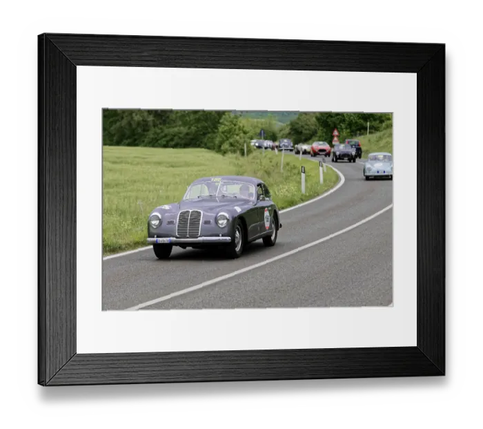 Framed Print : Grey vintage car with race number on a country road