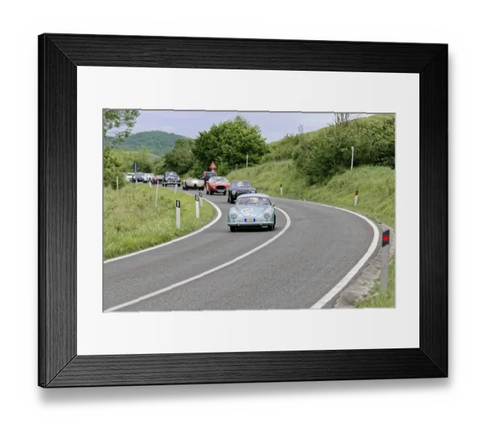 Framed Print : Blue vintage car leads a group of classic cars on a winding country road