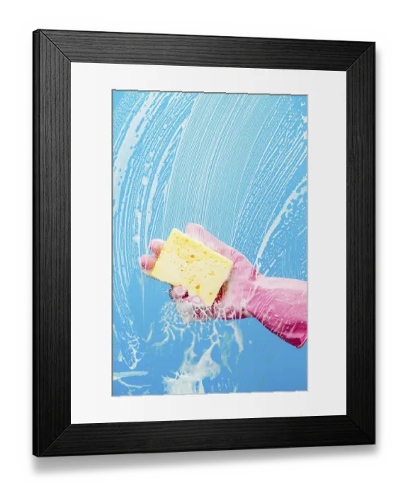 Framed Print : Person cleans glass with sponge on blue background