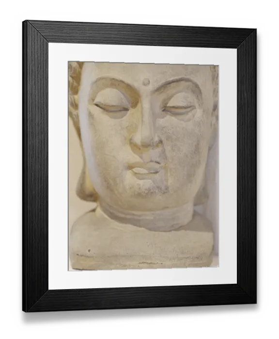 Framed Print : A statue of a face with a serene expression Framed Print : A statue of a face with a serene expression
