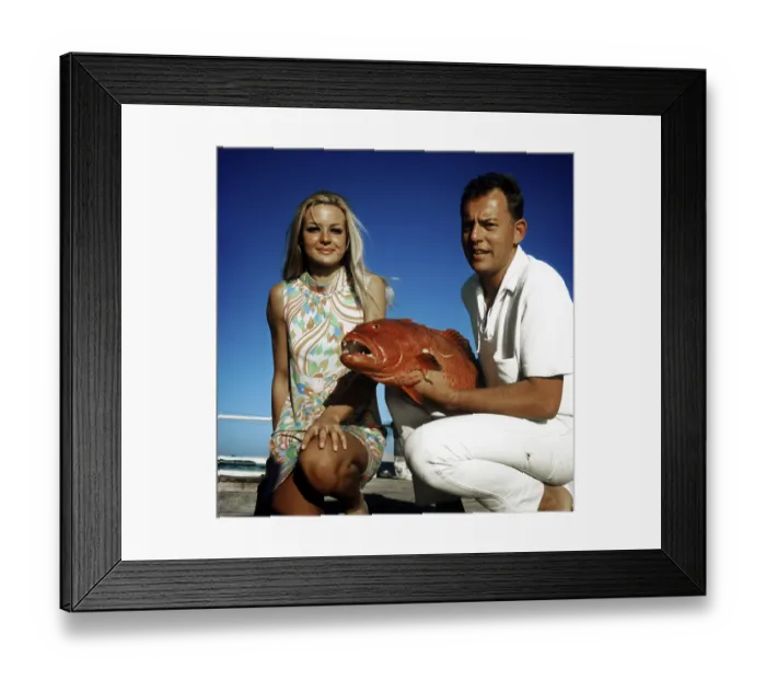 Framed Print : Couple posing with a trout grouper (Plectropomus pessuliferus)