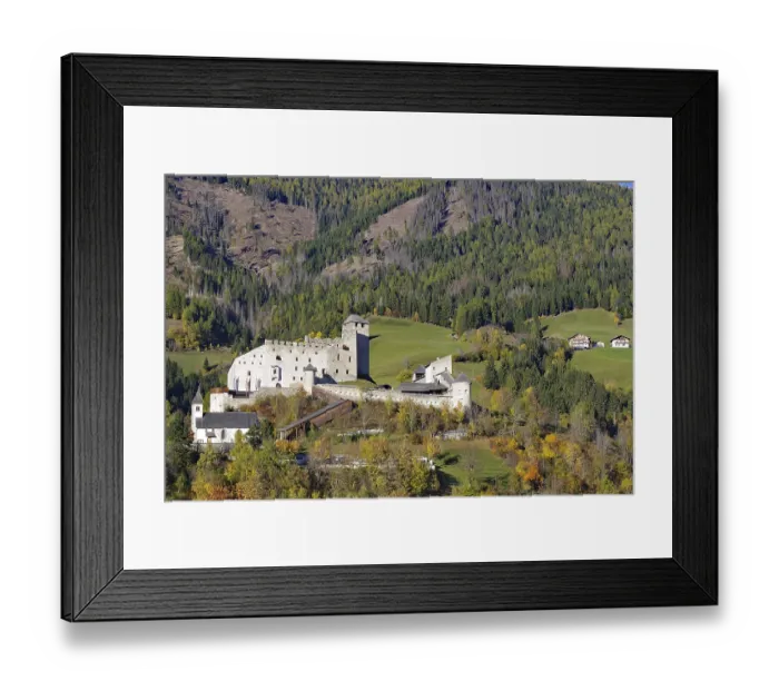 Framed Print : Medieval castle over autumnal forests and meadows in a sunny mountain landscape