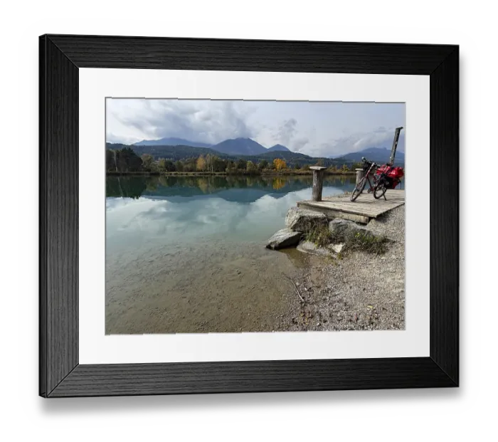 Framed Print : A bicycle is leaning on a footbridge over a still lake