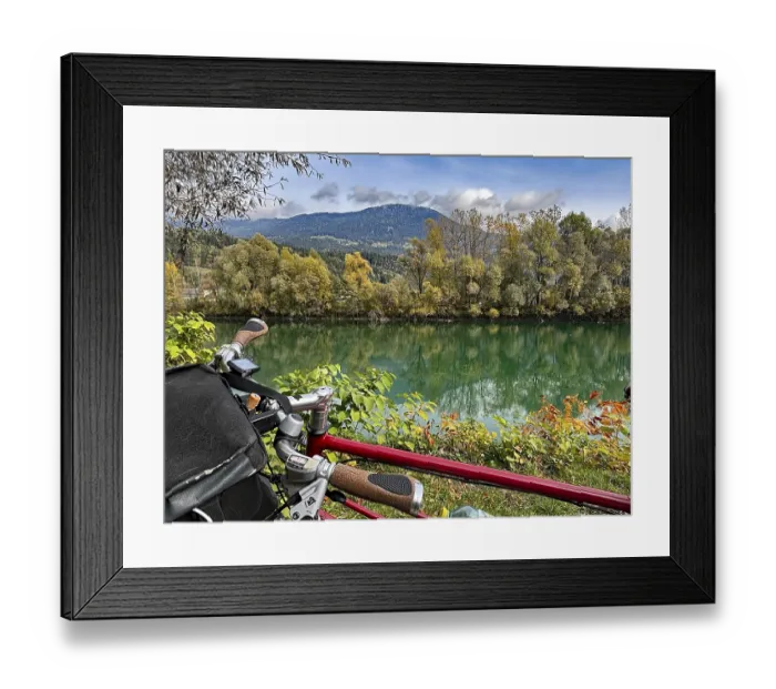 Framed Print : View over the handlebar of a shimmering green river in front of autumn trees and mountains Framed Print : View over the handlebar of a shimmering green river in front of autumn trees and mountains