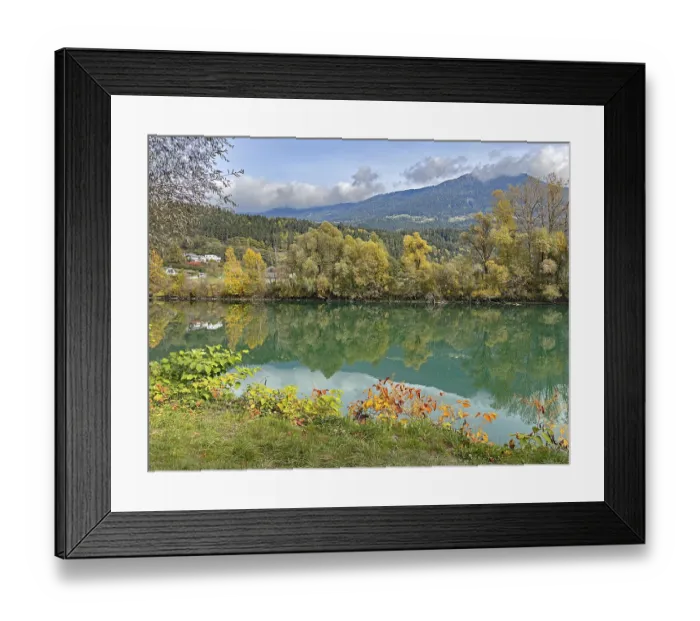 Framed Print : Calm river reflecting autumnal trees and mountains under cloudy sky Framed Print : Calm river reflecting autumnal trees and mountains under cloudy sky
