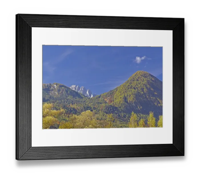 Framed Print : Autumn alpine slopes with round and jagged peaks under clear
