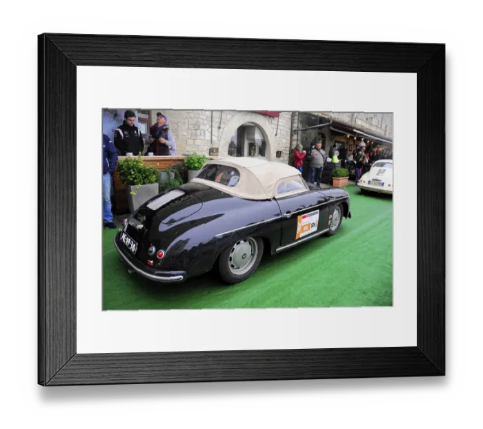 Framed Print : Black Porsche convertible with beige soft top drives relaxed through the old town at a classic car rally Framed Print : Black Porsche convertible with beige soft top drives relaxed through the old town at a classic car rally