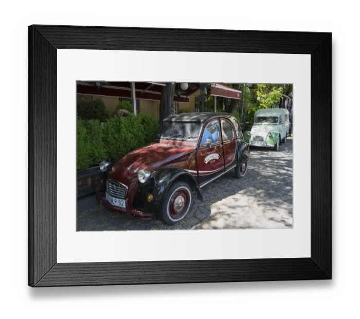 Framed Print : Two old Citroen cars are parked on a shady road