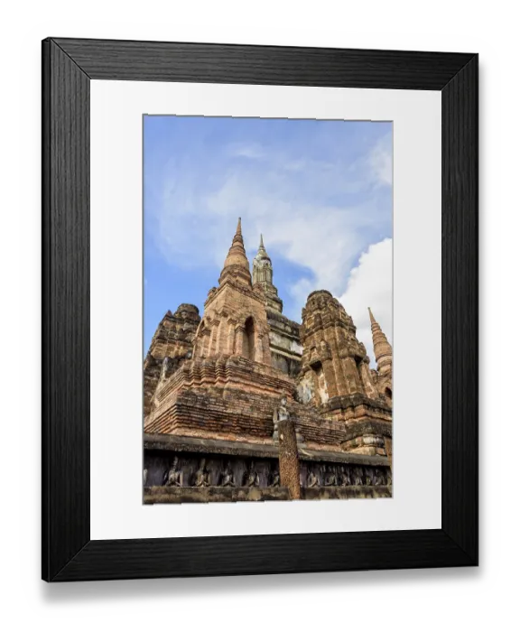 Framed Print : Ancient brick pagoda under the blue sky at Wat Maha That temple in Sukhothai Historical Park is an old capital