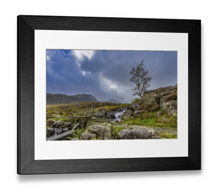 Framed Print : Wooden bridge leading to mountain's Snowdonia National Park