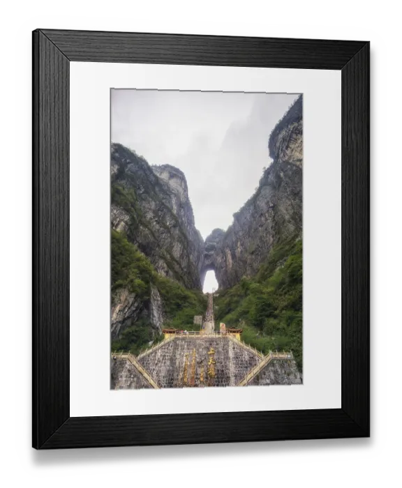 Framed Print : Tianmen cave or heavens door. a large water eroded hole between the two peaks