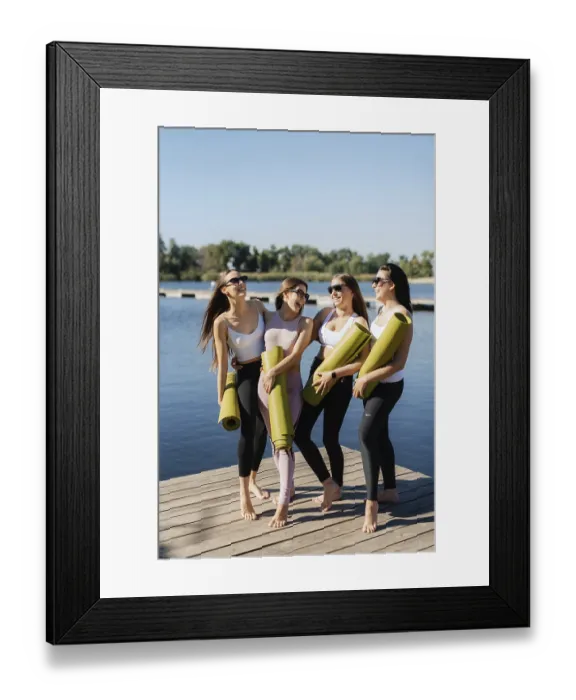 Framed Print : Group of young girls doing yoga outdoors and near the water