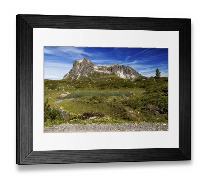 Framed Print : A small lake nestled in an alpine landscape with the distinctive GroBer Widderstein mountain