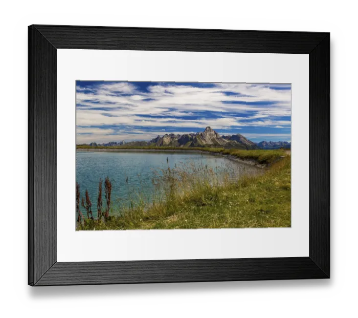 Framed Print : The panoramic lake at Saloberkopf with mountains in the background under a blue sky Framed Print : The panoramic lake at Saloberkopf with mountains in the background under a blue sky