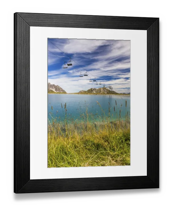 Framed Print : The panoramic lake on Saloberkopf with cable car and mountains in the background under a blue sky Framed Print : The panoramic lake on Saloberkopf with cable car and mountains in the background under a blue sky
