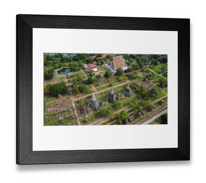 Framed Print : An ancient temple complex next to a city and a modern temple
